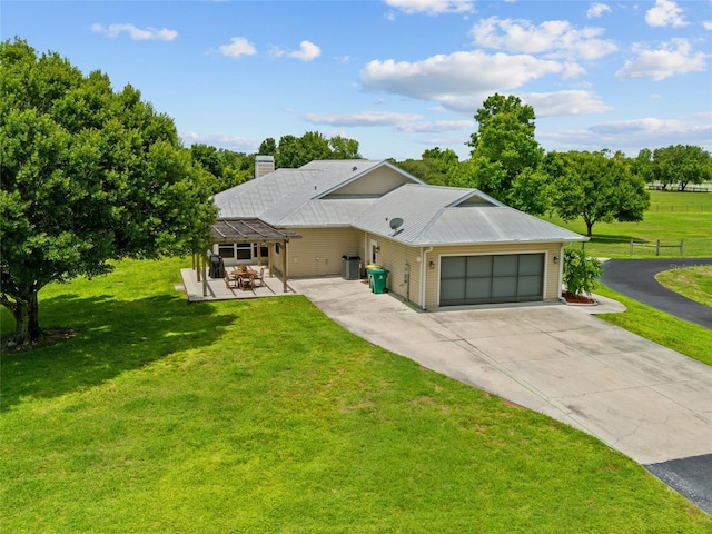 5221 Blackjack Cir, Punta Gorda, FL 33982 - view of front of house featuring a garage, driveway, a chimney, and a metal roof