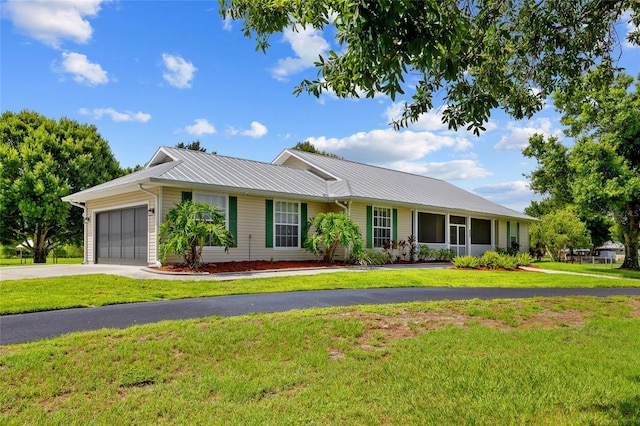 5221 Blackjack Cir, Punta Gorda, FL 33982 - ranch-style home with a garage, a front yard, driveway, and a metal roof