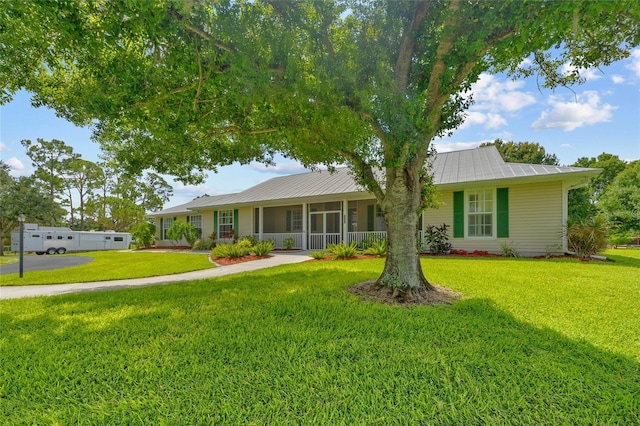 5221 Blackjack Cir, Punta Gorda, FL 33982 - ranch-style home featuring a front yard and a metal roof