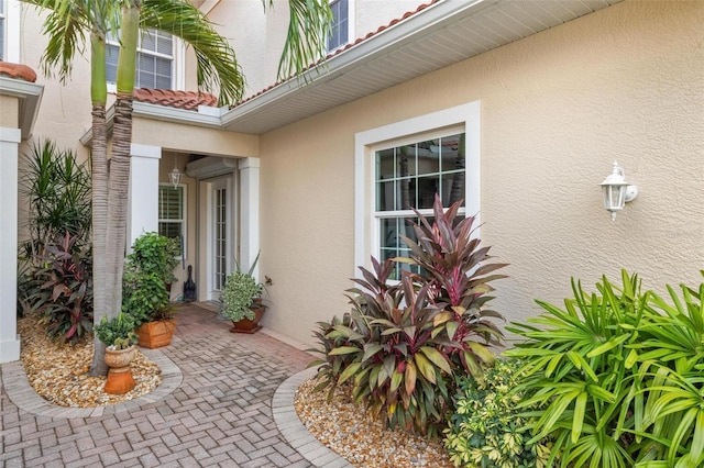 2630 Tarpon Cove Dr Unit 212, Punta Gorda, FL 33950 - view of exterior entry featuring stucco siding and a tile roof