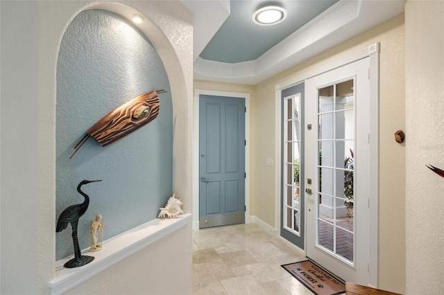 2630 Tarpon Cove Dr Unit 212, Punta Gorda, FL 33950 - doorway to outside featuring a textured wall, light stone finish flooring, and baseboards