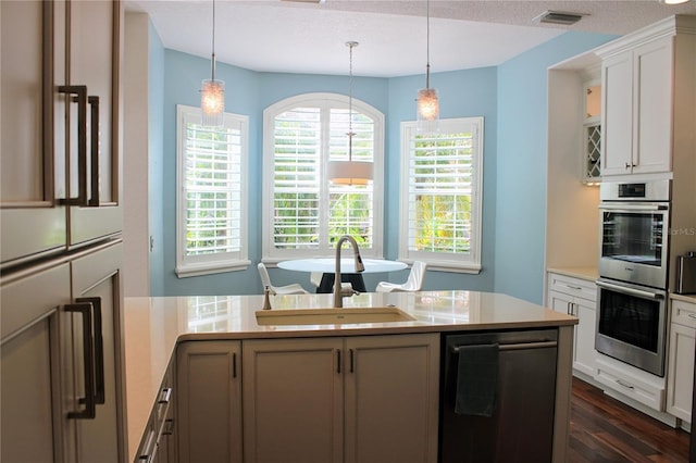 2630 Tarpon Cove Dr Unit 212, Punta Gorda, FL 33950 - kitchen with a sink, stainless steel appliances, dark wood-style flooring, light countertops, and decorative light fixtures