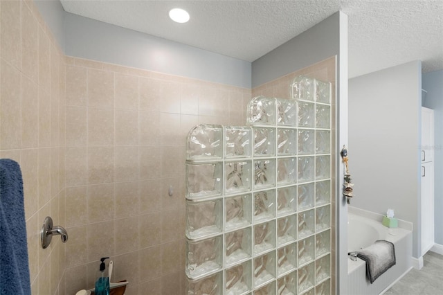 2630 Tarpon Cove Dr Unit 212, Punta Gorda, FL 33950 - full bath with walk in shower, a bath, and a textured ceiling