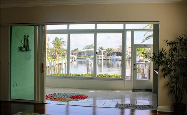 2630 Tarpon Cove Dr Unit 212, Punta Gorda, FL 33950 - dining room with a water view, crown molding, wood finished floors, and a residential view