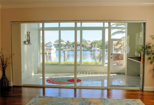2630 Tarpon Cove Dr Unit 212, Punta Gorda, FL 33950 - doorway to outside with wood finished floors, ornamental molding, a water view, and baseboards