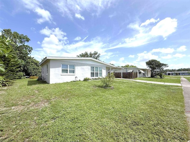22334 Augusta Ave, Port Charlotte, FL 33952 - view of front of property featuring a front lawn, stucco siding, concrete driveway, and an attached carport