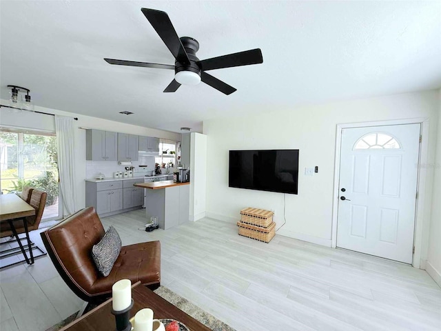 22334 Augusta Ave, Port Charlotte, FL 33952 - living room featuring healthy amount of natural light, ceiling fan, and light wood-style floors
