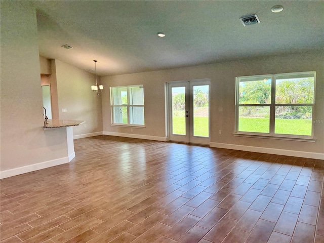 10023 Greetings St, Port Charlotte, FL 33981 - unfurnished living room with dark wood-type flooring, vaulted ceiling, recessed lighting, a chandelier, and a textured ceiling