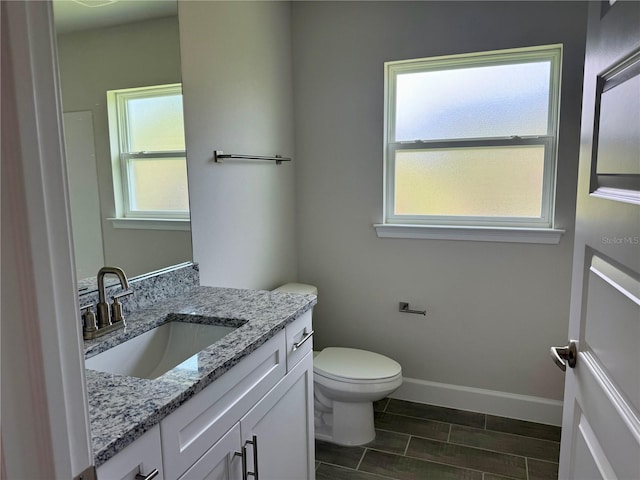 10023 Greetings St, Port Charlotte, FL 33981 - bathroom featuring vanity, plenty of natural light, and wood finish floors