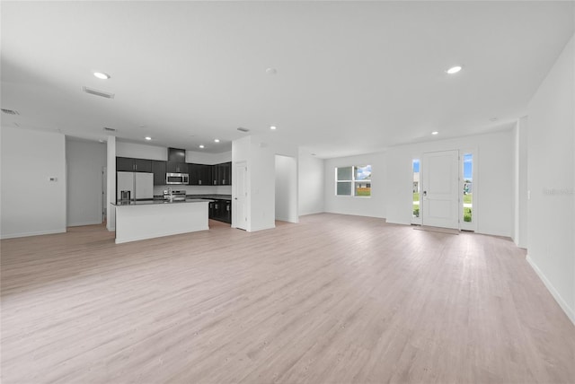 2138 Blaser St, Punta Gorda, FL 33980 - unfurnished living room featuring light wood finished floors and recessed lighting