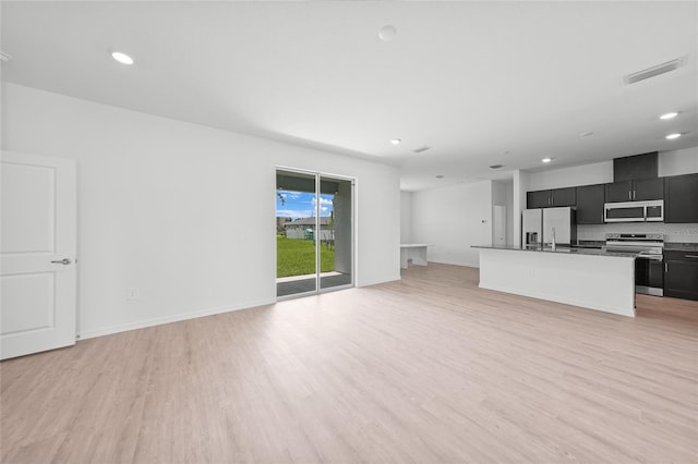 2138 Blaser St, Punta Gorda, FL 33980 - unfurnished living room with light wood-style flooring and recessed lighting