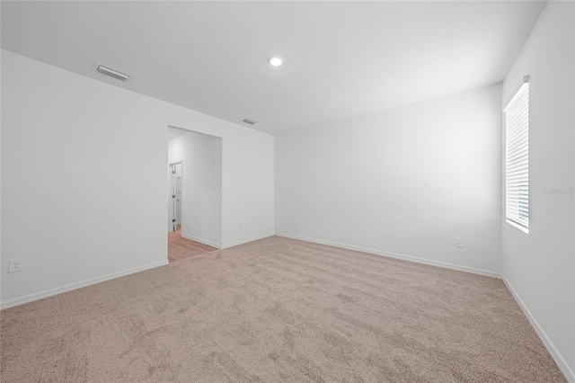 2138 Blaser St, Punta Gorda, FL 33980 - empty room featuring light carpet and plenty of natural light