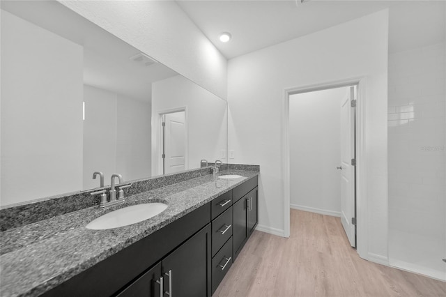2138 Blaser St, Punta Gorda, FL 33980 - full bath with double vanity, wood finished floors, and a tile shower