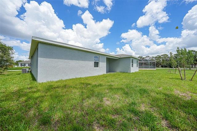 2138 Blaser St, Punta Gorda, FL 33980 - rear view of house with stucco siding and a yard