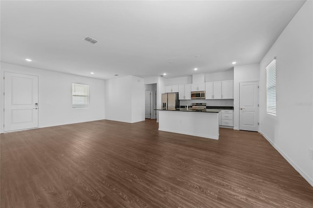 7345 Ellis Ln, Port Charlotte, FL 33981 - kitchen with stainless steel appliances, dark countertops, open floor plan, recessed lighting, and dark wood finished floors