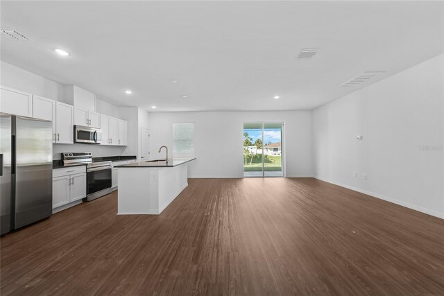 7345 Ellis Ln, Port Charlotte, FL 33981 - kitchen with stainless steel appliances, dark countertops, dark wood-style floors, open floor plan, and recessed lighting