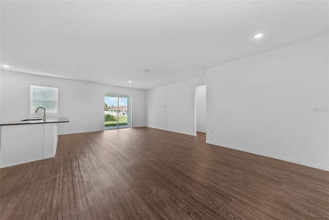 7345 Ellis Ln, Port Charlotte, FL 33981 - unfurnished living room with dark wood-type flooring and recessed lighting