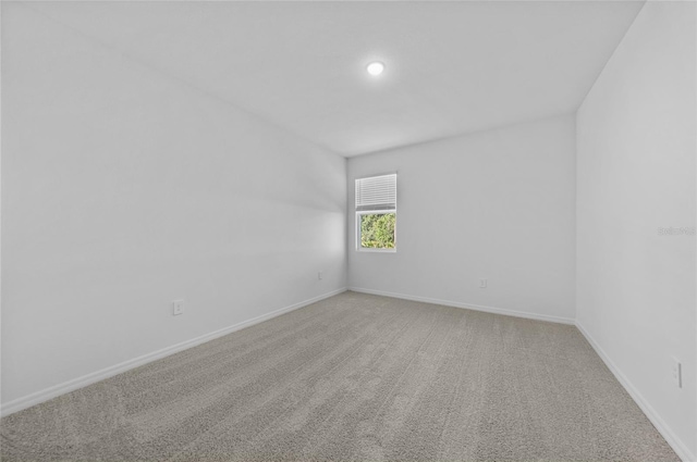 7345 Ellis Ln, Port Charlotte, FL 33981 - spare room featuring light colored carpet and baseboards