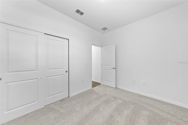 7345 Ellis Ln, Port Charlotte, FL 33981 - unfurnished bedroom featuring carpet floors and a closet
