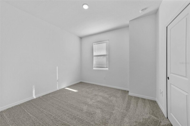 7345 Ellis Ln, Port Charlotte, FL 33981 - carpeted spare room with baseboards and a smoke detector