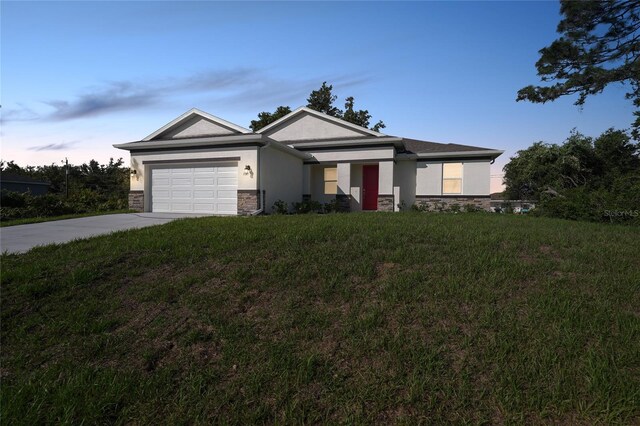 7345 Ellis Ln, Port Charlotte, FL 33981 - ranch-style house featuring stucco siding, concrete driveway, stone siding, an attached garage, and a lawn
