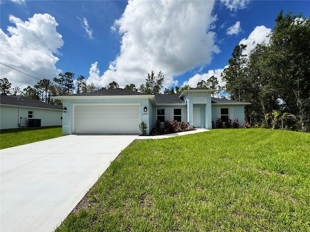 2451 Waller Rd, North Port, FL 34288 - ranch-style house with an attached garage, concrete driveway, a front lawn, and stucco siding