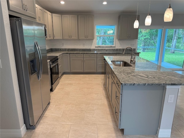 2451 Waller Rd, North Port, FL 34288 - kitchen with appliances with stainless steel finishes, gray cabinetry, dark stone counters, tasteful backsplash, and recessed lighting
