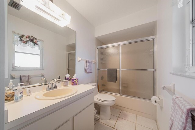 405 Ridgecrest Dr, Punta Gorda, FL 33982 - full bathroom featuring toilet, vanity, tile patterned flooring, and bath / shower combo with glass door