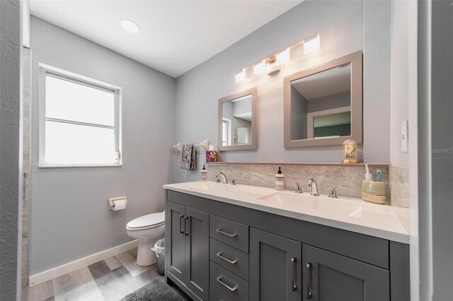 405 Ridgecrest Dr, Punta Gorda, FL 33982 - full bath with wood finished floors, double vanity, toilet, and baseboards