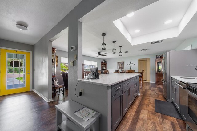 405 Ridgecrest Dr, Punta Gorda, FL 33982 - kitchen with dark wood finished floors, a tray ceiling, baseboards, ceiling fan, and hanging light fixtures