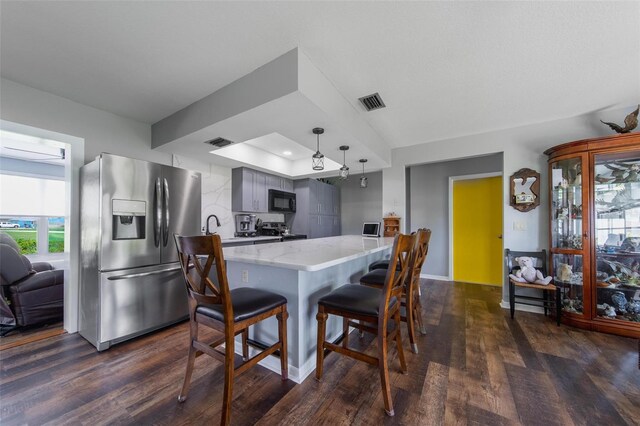 405 Ridgecrest Dr, Punta Gorda, FL 33982 - kitchen featuring stainless steel appliances, dark wood-type flooring, a kitchen breakfast bar, and light stone countertops