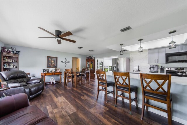 405 Ridgecrest Dr, Punta Gorda, FL 33982 - living area with dark wood finished floors and ceiling fan