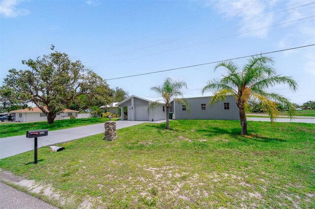 405 Ridgecrest Dr, Punta Gorda, FL 33982 - view of front facade with concrete driveway, a front yard, and an attached garage