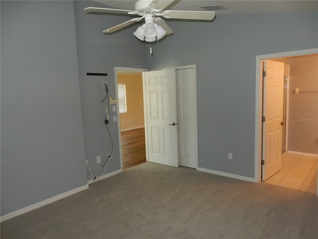 500 Winwood Ct, Port Charlotte, FL 33954 - unfurnished bedroom with carpet, a closet, connected bathroom, and ceiling fan