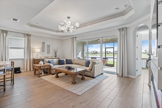 15039 Black Cherry Way, Punta Gorda, FL 33955 - living area with a raised ceiling, healthy amount of natural light, light wood-style floors, a chandelier, and crown molding