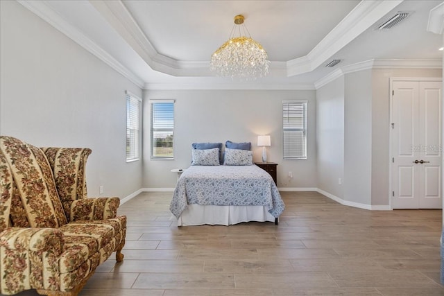 15039 Black Cherry Way, Punta Gorda, FL 33955 - bedroom with a chandelier, light wood-type flooring, a raised ceiling, and crown molding