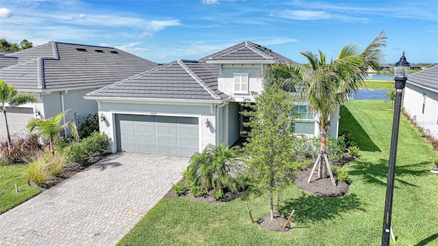15039 Black Cherry Way, Punta Gorda, FL 33955 - traditional home with a garage, a tile roof, decorative driveway, a front yard, and stucco siding
