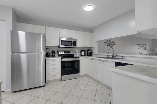 196 Furse Lakes Cir Unit A6, Naples, FL 34104 - kitchen with stainless steel appliances, a sink, light countertops, and white cabinets