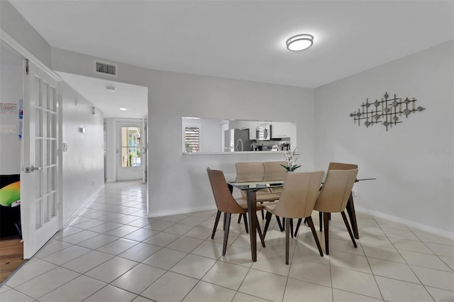 196 Furse Lakes Cir Unit A6, Naples, FL 34104 - dining area with light tile patterned floors, baseboards, and french doors