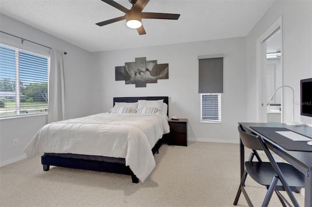 196 Furse Lakes Cir Unit A6, Naples, FL 34104 - bedroom featuring carpet floors, baseboards, connected bathroom, and ceiling fan