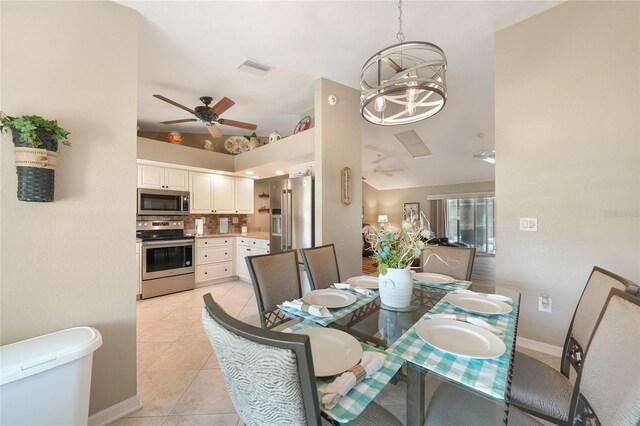 37 Pepe Ct, Punta Gorda, FL 33983 - dining space featuring ceiling fan, light tile patterned floors, a chandelier, and a towering ceiling