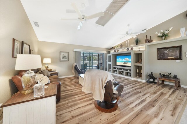 37 Pepe Ct, Punta Gorda, FL 33983 - living area with a ceiling fan, light wood-type flooring, built in shelves, and high vaulted ceiling