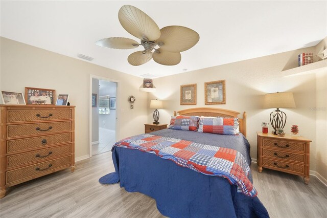 37 Pepe Ct, Punta Gorda, FL 33983 - bedroom with wood finished floors, a ceiling fan, and connected bathroom