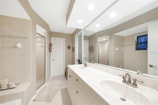 37 Pepe Ct, Punta Gorda, FL 33983 - bathroom with a shower stall, tile patterned floors, double vanity, and recessed lighting