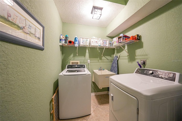 37 Pepe Ct, Punta Gorda, FL 33983 - washroom featuring washer and dryer, a textured ceiling, a textured wall, and light tile patterned floors