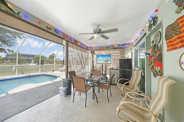 37 Pepe Ct, Punta Gorda, FL 33983 - sunroom / solarium with ceiling fan, a swimming pool, and outdoor dining area