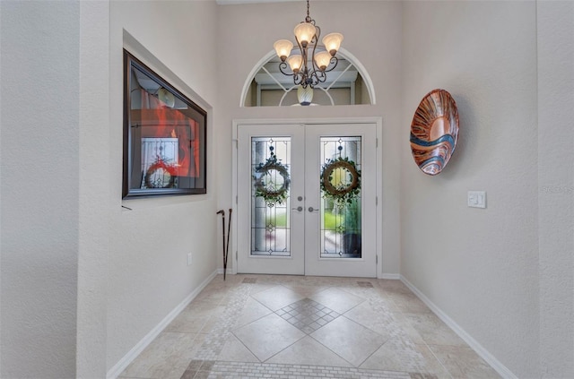 250 Freeport Ct, Punta Gorda, FL 33950 - entryway featuring a chandelier, french doors, a high ceiling, and light tile patterned flooring