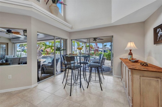250 Freeport Ct, Punta Gorda, FL 33950 - dining area featuring ceiling fan, light tile patterned floors, and a high ceiling