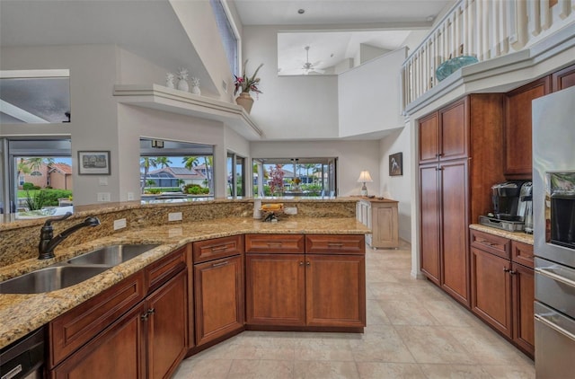 250 Freeport Ct, Punta Gorda, FL 33950 - kitchen with a ceiling fan, a towering ceiling, stainless steel fridge with ice dispenser, light stone counters, and light tile patterned floors