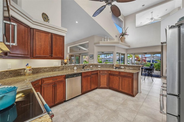 250 Freeport Ct, Punta Gorda, FL 33950 - kitchen featuring stainless steel appliances, a ceiling fan, high vaulted ceiling, light stone countertops, and a peninsula